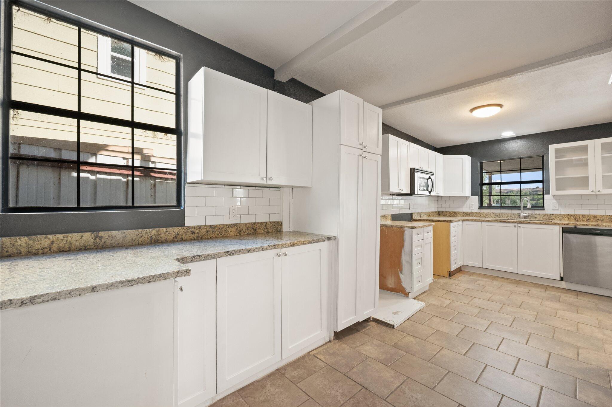 69 Pony Express Trail Lubbock, TX 79404 - Photo 18 of 39 a kitchen with granite countertop white cabinets and white appliances
