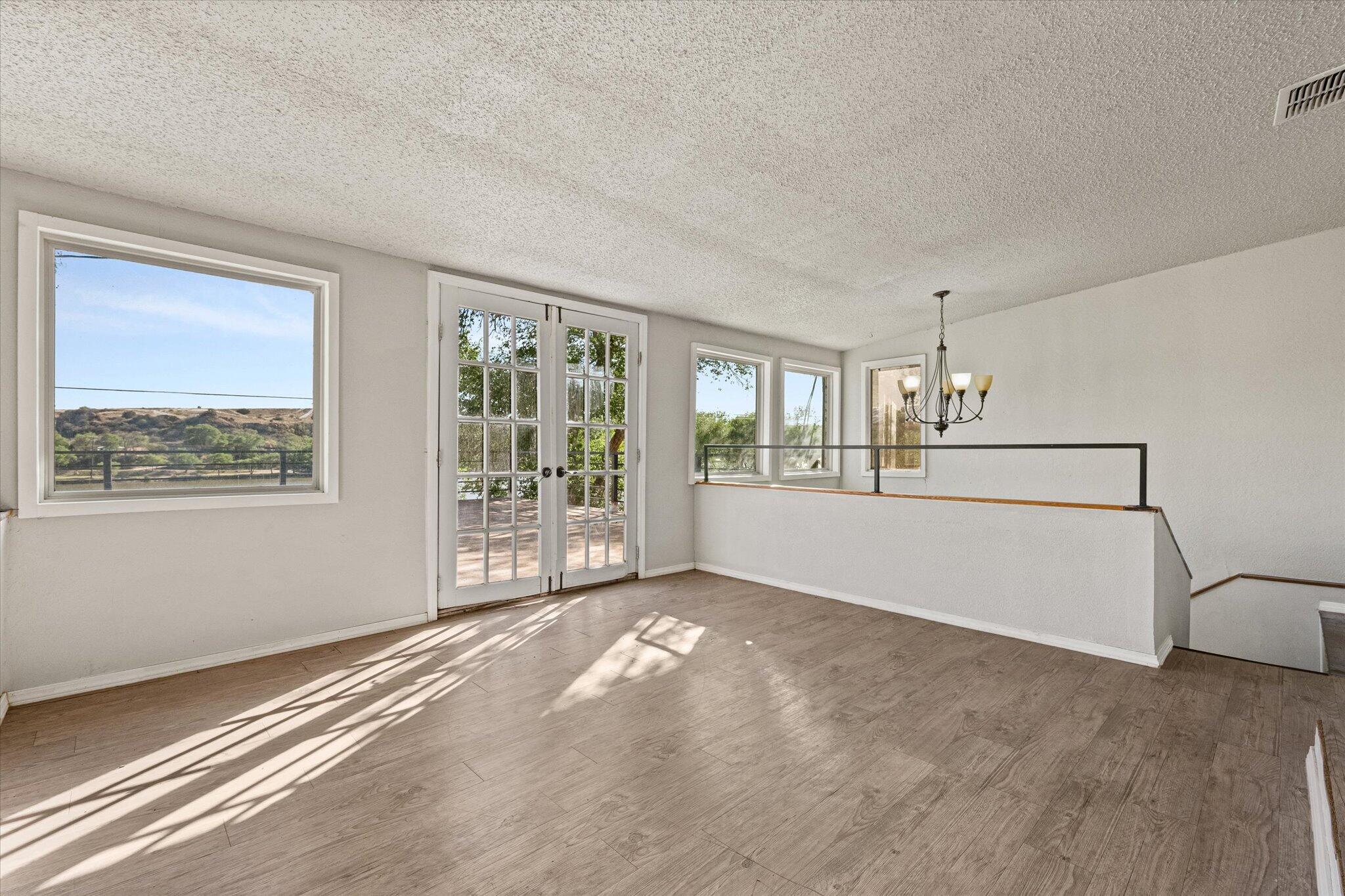 69 Pony Express Trail Lubbock, TX 79404 - Photo 21 of 39 a view of a big room with windows and chandelier fan
