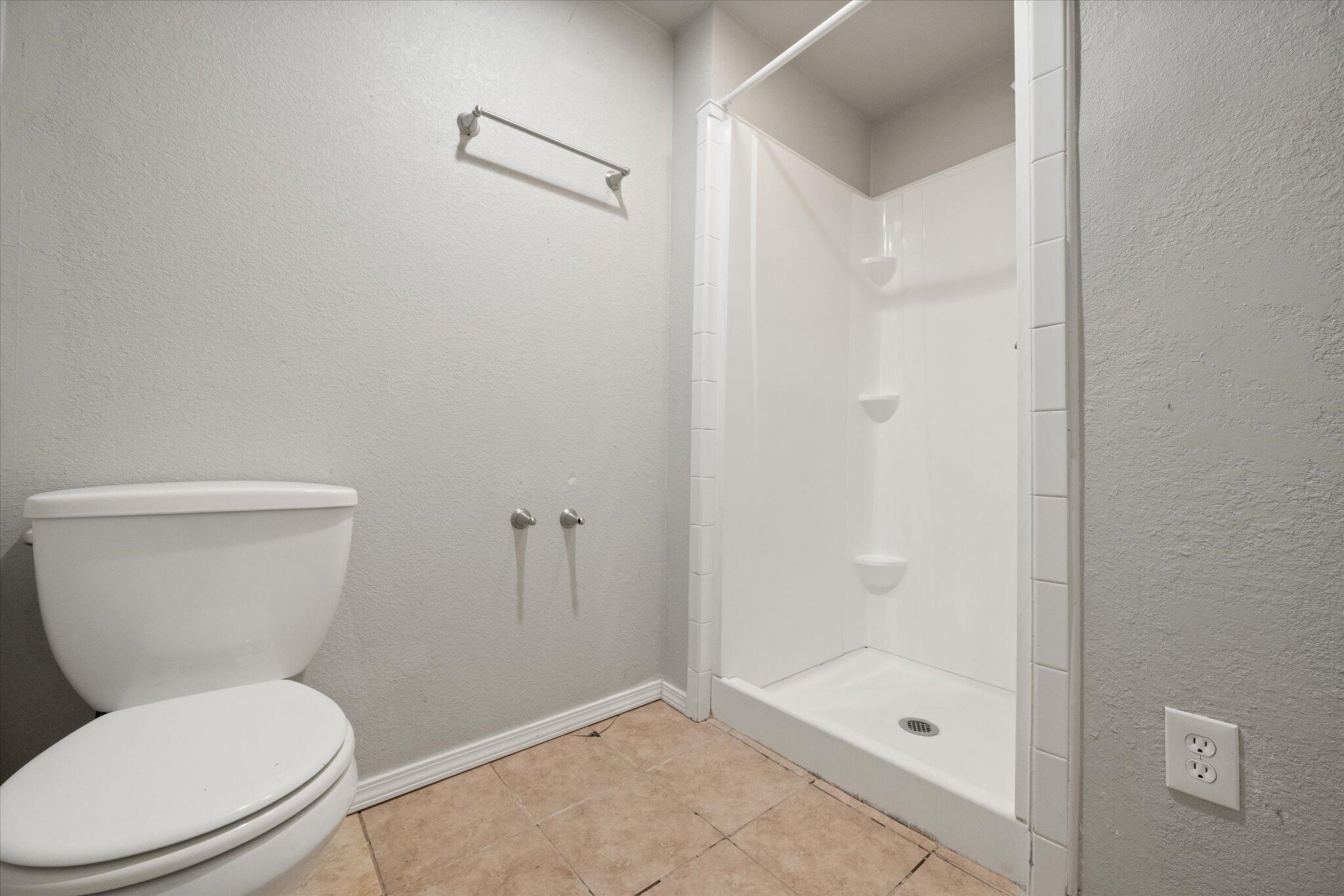 69 Pony Express Trail Lubbock, TX 79404 - Photo 25 of 39 a white toilet sitting next to a bath tub