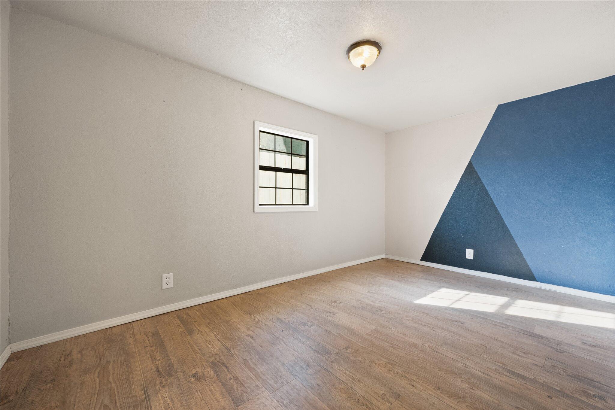 69 Pony Express Trail Lubbock, TX 79404 - Photo 27 of 39 an empty room with wooden floor and windows