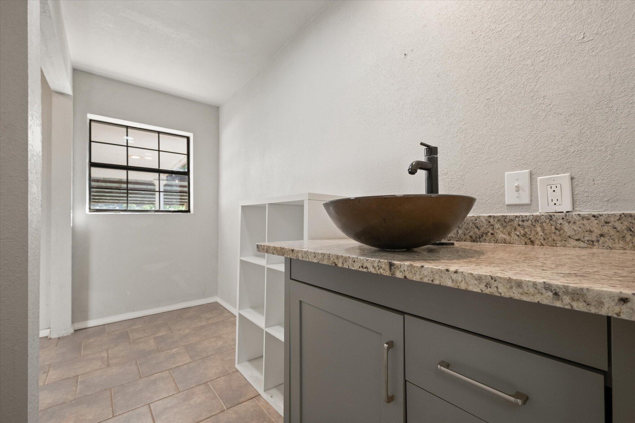 69 Pony Express Trail Lubbock, TX 79404 - Photo 31 of 39 a kitchen with a granite countertop sink and cabinets