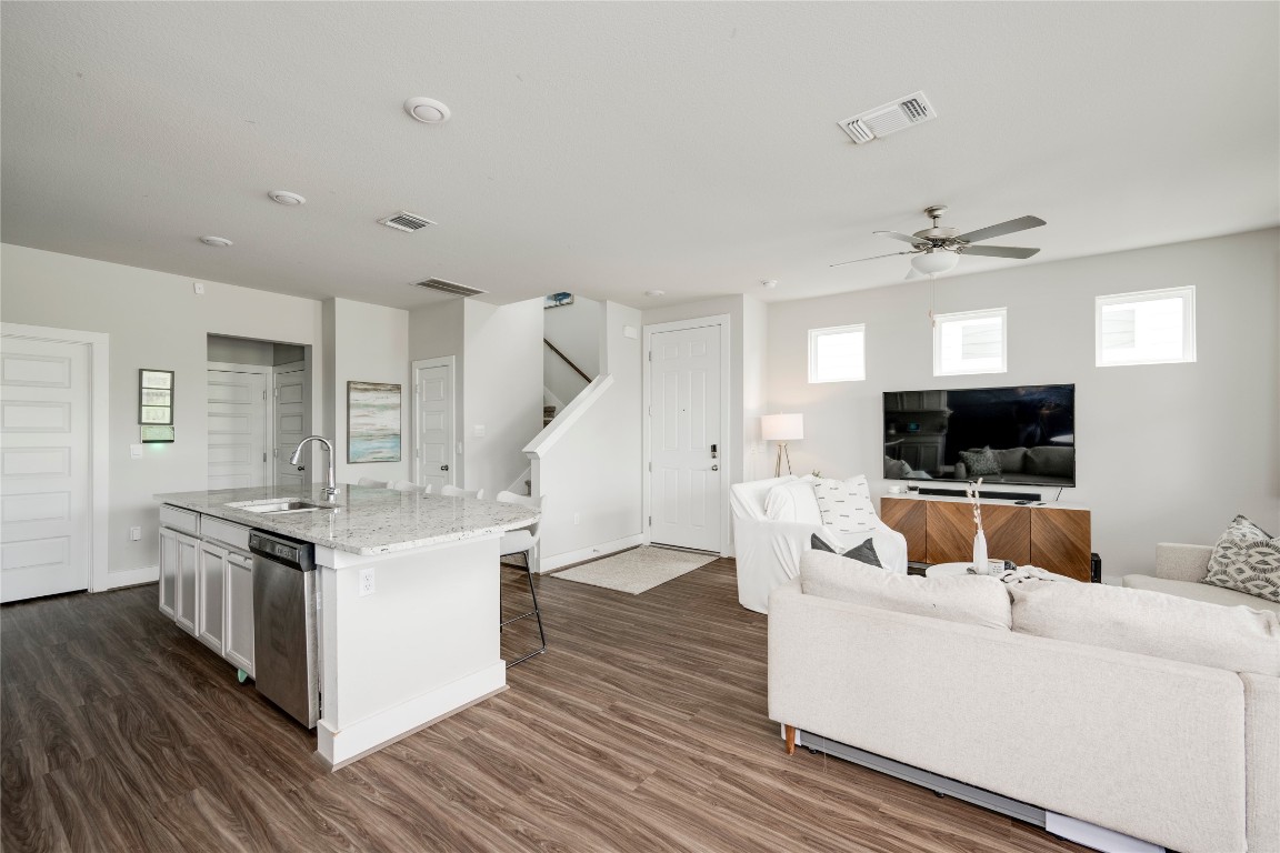 7502 Chesapeake Rail Lane, Unit 154 Austin, TX 78744 - Photo 11 of 40 a living room with furniture and a flat screen tv