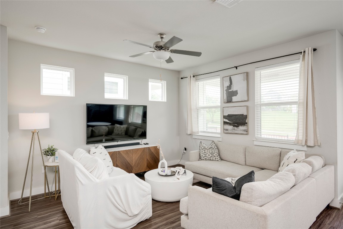 7502 Chesapeake Rail Lane, Unit 154 Austin, TX 78744 - Photo 12 of 40 a living room with furniture and a flat screen tv