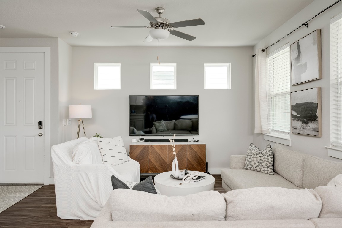 7502 Chesapeake Rail Lane, Unit 154 Austin, TX 78744 - Photo 13 of 40 a living room with furniture and a flat screen tv