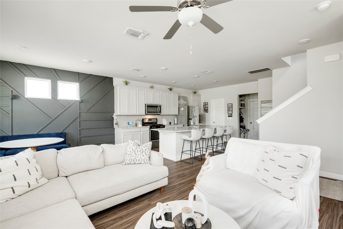7502 Chesapeake Rail Lane, Unit 154 Austin, TX 78744 - Photo 15 of 40 a living room with furniture kitchen view and a chandelier
