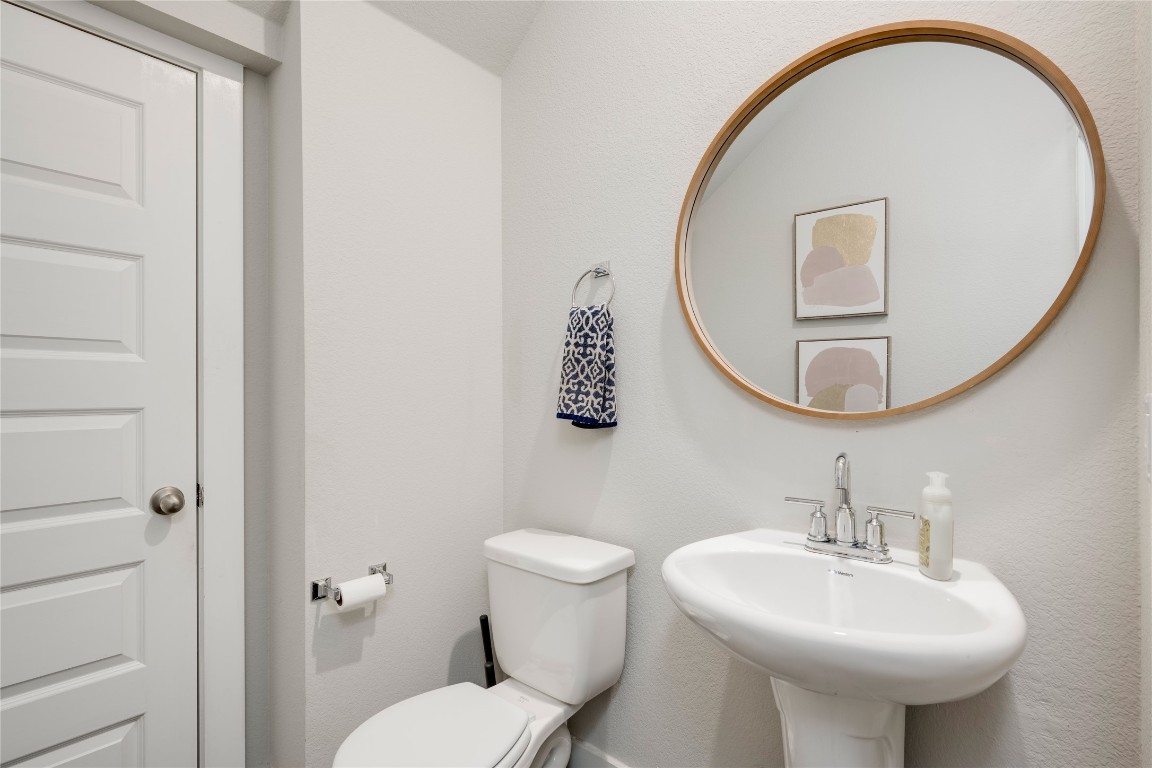 7502 Chesapeake Rail Lane, Unit 154 Austin, TX 78744 - Photo 17 of 40 a bathroom with a sink a mirror and a toilet