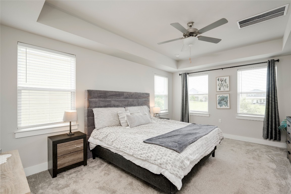 7502 Chesapeake Rail Lane, Unit 154 Austin, TX 78744 - Photo 19 of 40 a bedroom with a large bed and a window
