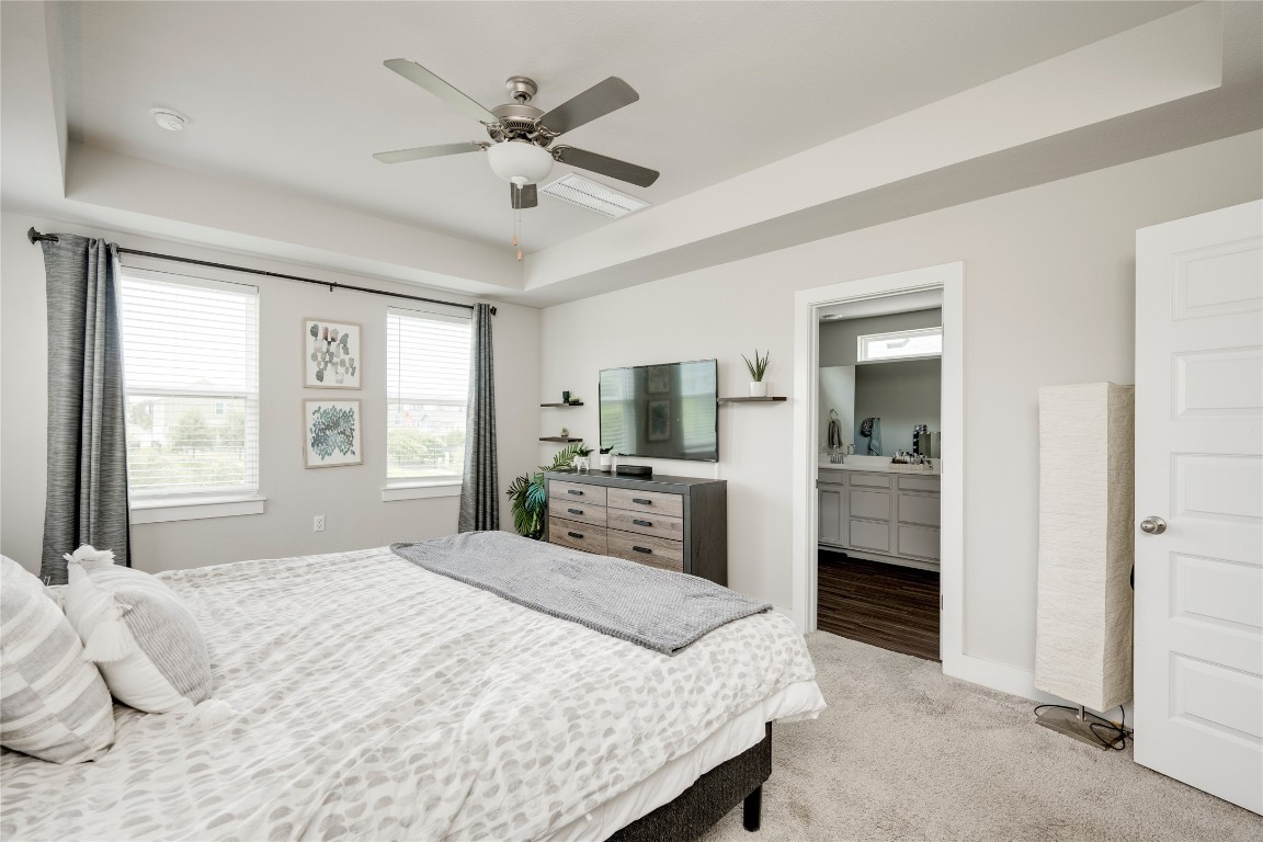 7502 Chesapeake Rail Lane, Unit 154 Austin, TX 78744 - Photo 20 of 40 a bedroom with a bed and a large window