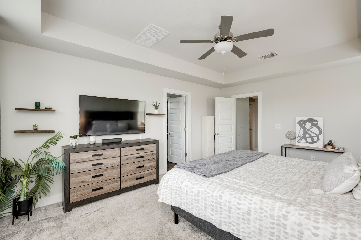 7502 Chesapeake Rail Lane, Unit 154 Austin, TX 78744 - Photo 21 of 40 a bedroom with a bed and a flat screen tv