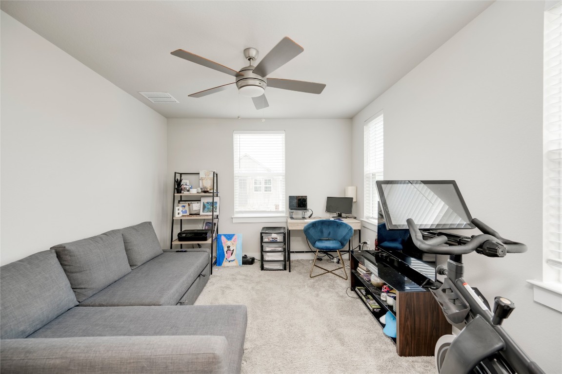 7502 Chesapeake Rail Lane, Unit 154 Austin, TX 78744 - Photo 27 of 40 a living room with furniture and a window