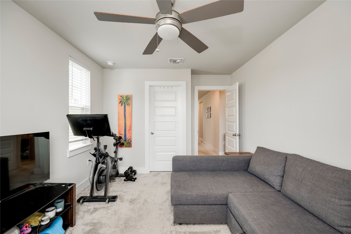 7502 Chesapeake Rail Lane, Unit 154 Austin, TX 78744 - Photo 29 of 40 a living room with furniture and a flat screen tv