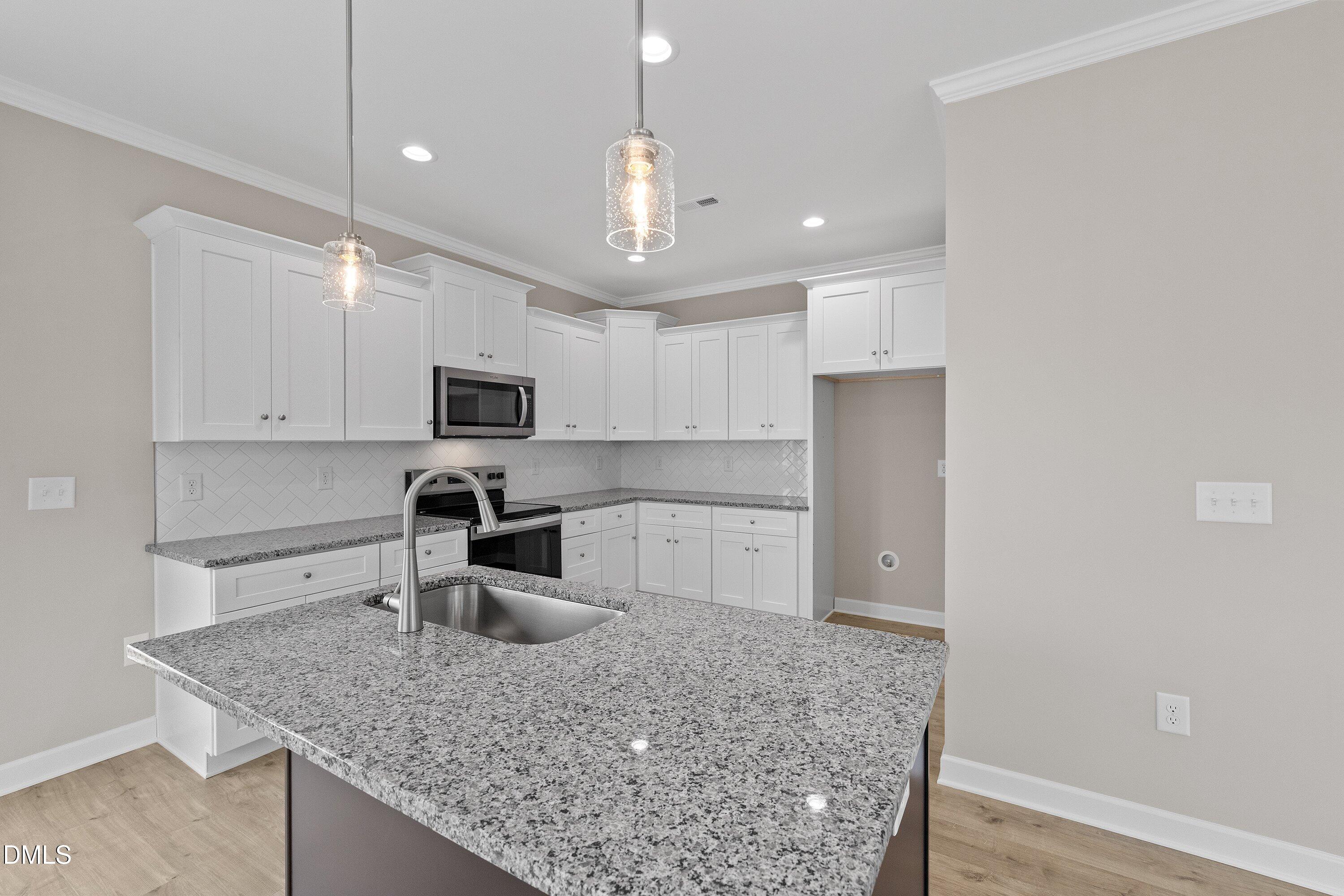 926 Micro Road West Selma, NC 27576 - Photo 21 of 41 a kitchen with stainless steel appliances granite countertop a sink refrigerator and microwave