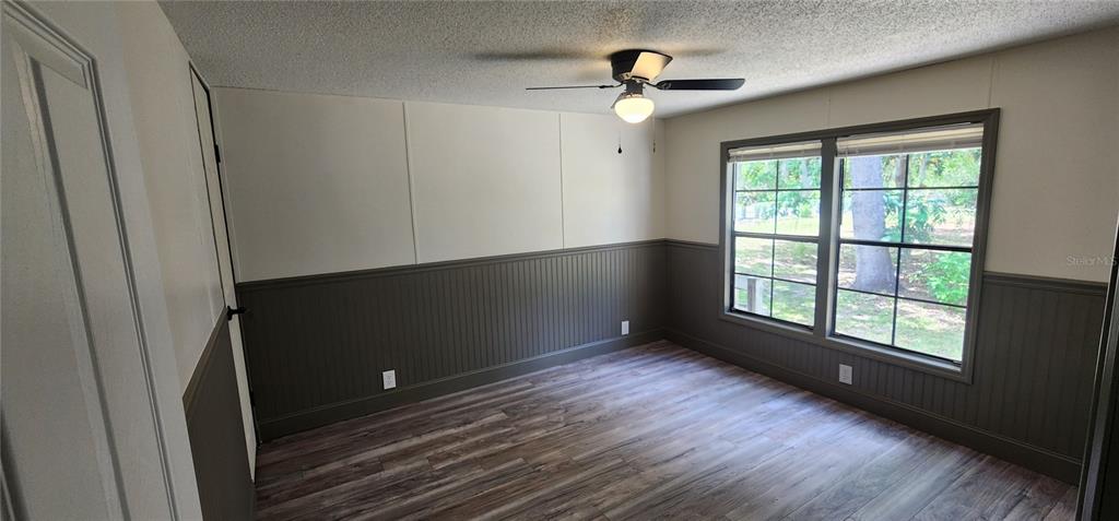19865 Southwest 5th Place Dunnellon, FL 34431 - Photo 64 of 78 a view of an empty room with a window and wooden floor