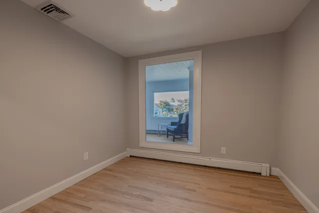 a view of a patio with couches chairs and a potted plant on the table