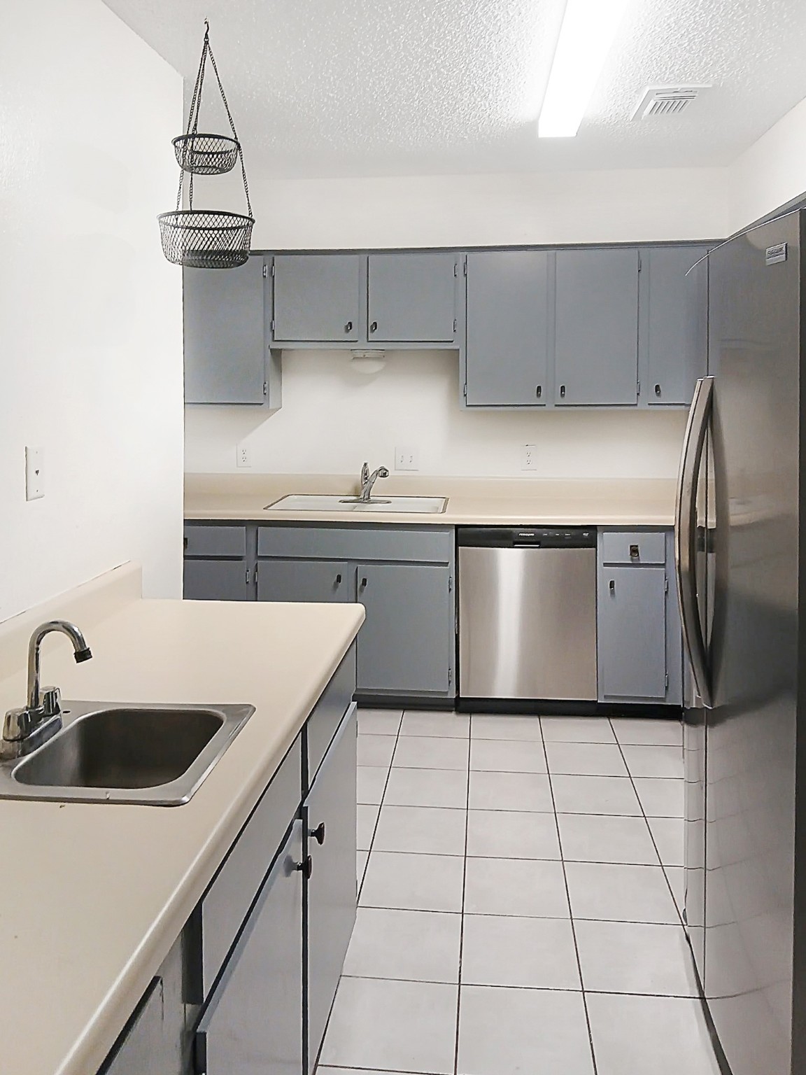 6601 Sands Point Drive, Unit 5 Houston, TX 77074 - Photo 2 of 6 a kitchen with stainless steel appliances a sink a stove a refrigerator and cabinets
