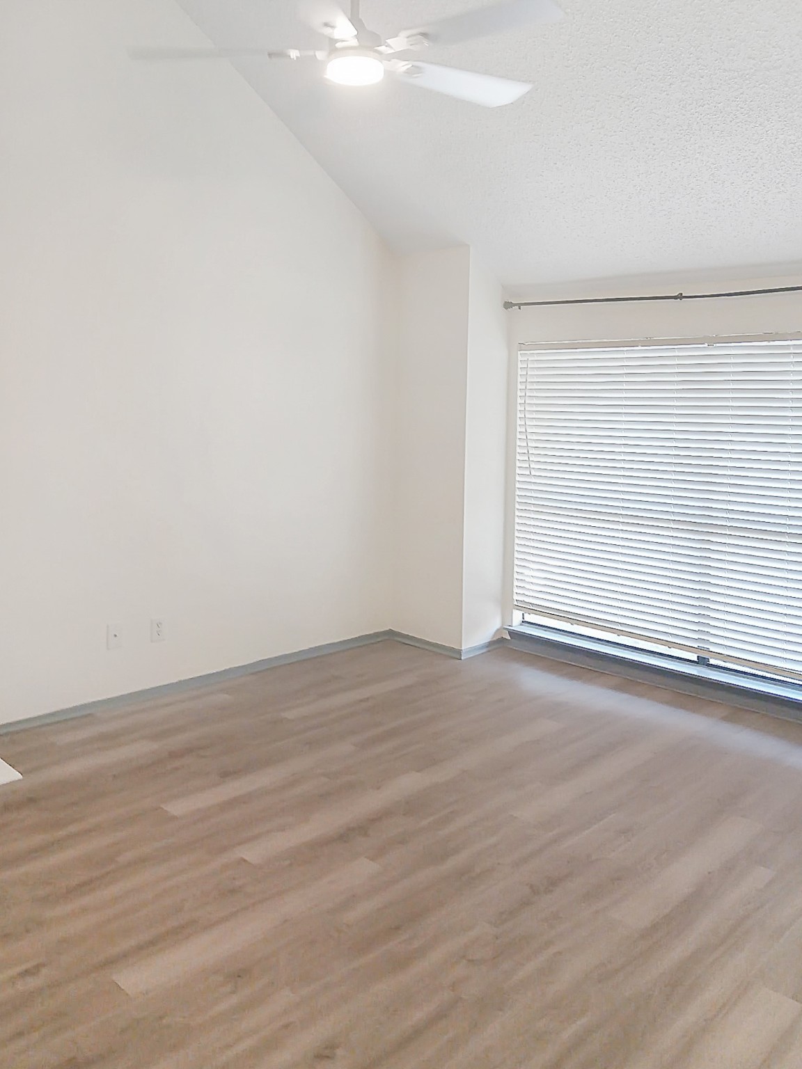 6601 Sands Point Drive, Unit 5 Houston, TX 77074 - Photo 4 of 6 an empty room with wooden floor and windows