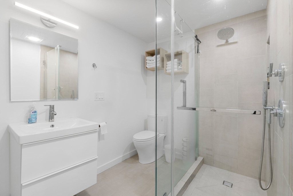 99 Upland Road Cambridge, MA 02140 - Photo 9 of 16 a bathroom with a sink a toilet and shower
