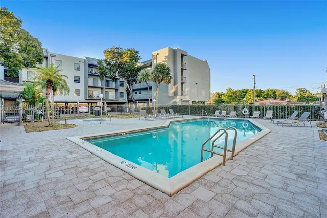 a view of a swimming pool with a lounge chairs