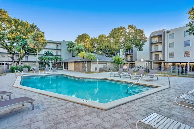 a large swimming pool with outdoor seating and yard
