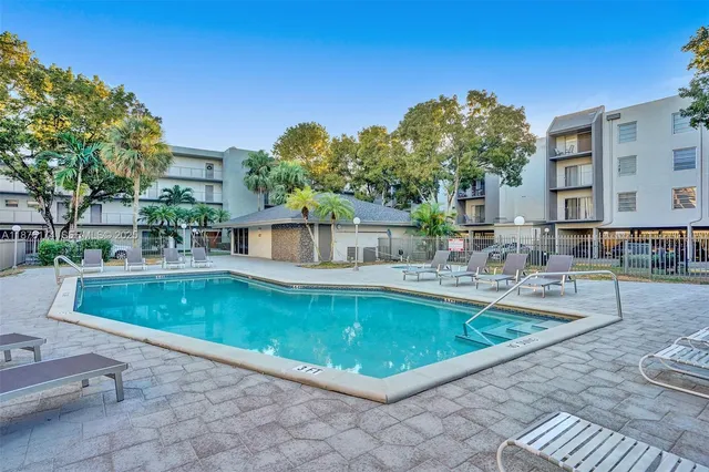 a large swimming pool with outdoor seating and yard