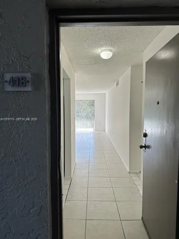 a kitchen with white cabinets a refrigerator and a stove top oven