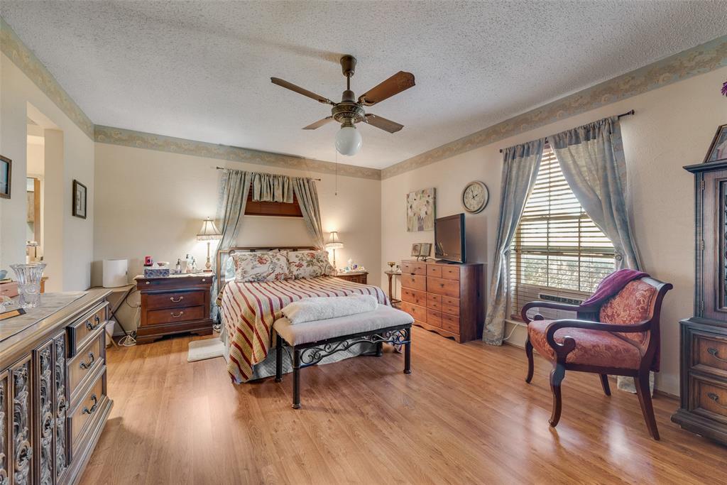 830 Mt Zion Road Midlothian, TX 76065 - Photo 18 of 36 Primary bedroom with wood laminate flooring and ceiling fan