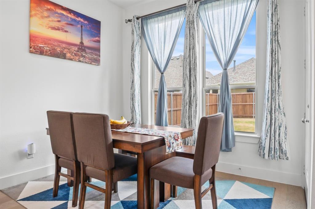 1255 Sumner Street Aubrey, TX 76227 - Photo 11 of 40 a view of a dining room with furniture and a window