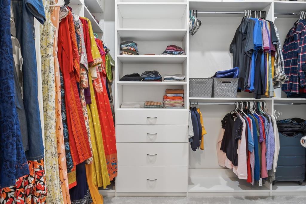 1255 Sumner Street Aubrey, TX 76227 - Photo 17 of 40 a view of walk in closet with clothes and shoes