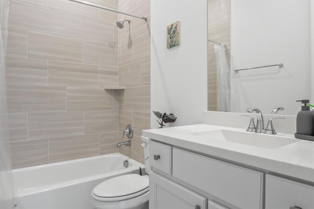 1255 Sumner Street Aubrey, TX 76227 - Photo 22 of 40 a bathroom with a sink toilet and shower