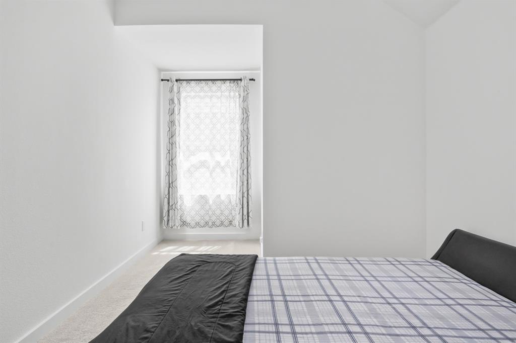 1255 Sumner Street Aubrey, TX 76227 - Photo 30 of 40 a bedroom with a bed and a window