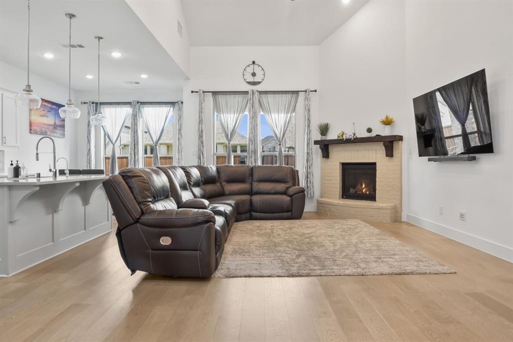 1255 Sumner Street Aubrey, TX 76227 - Photo 3 of 40 a living room with furniture and a fireplace