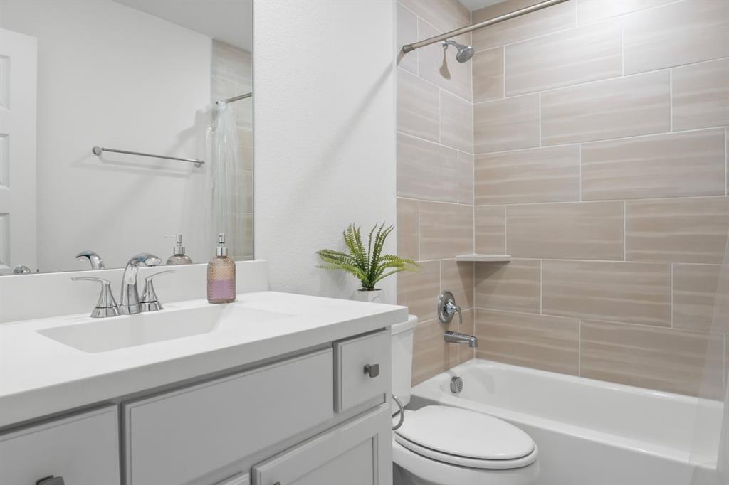 1255 Sumner Street Aubrey, TX 76227 - Photo 33 of 40 a bathroom with a sink a toilet and a bathtub