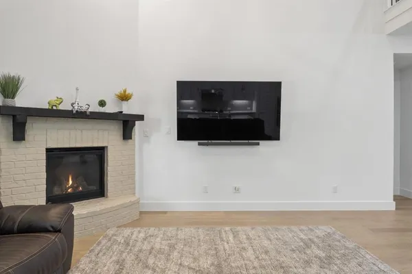 a living room with a fireplace and a flat screen tv
