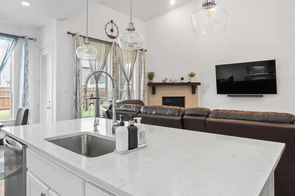 1255 Sumner Street Aubrey, TX 76227 - Photo 10 of 40 a living room with furniture and a flat screen tv
