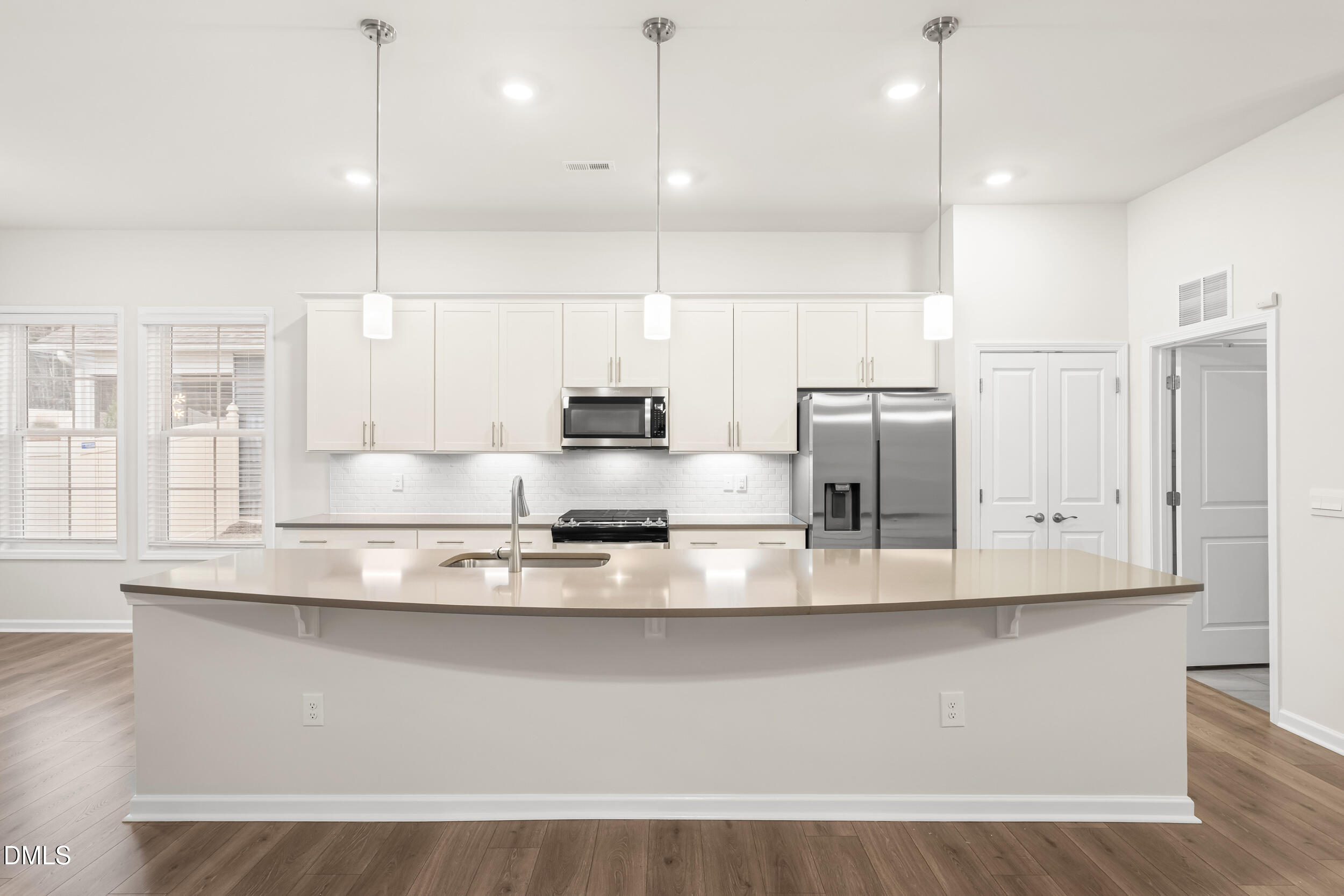 1 Bobby Parker Place Durham, NC 27703 - Photo 16 of 41 a large kitchen with kitchen island a large counter top stainless steel appliances and cabinets