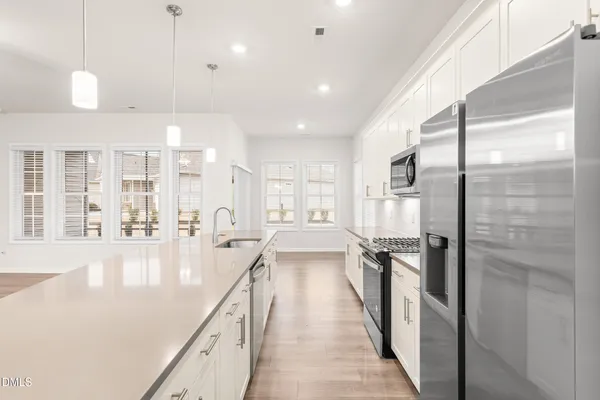 a kitchen with stainless steel appliances a refrigerator and cabinets