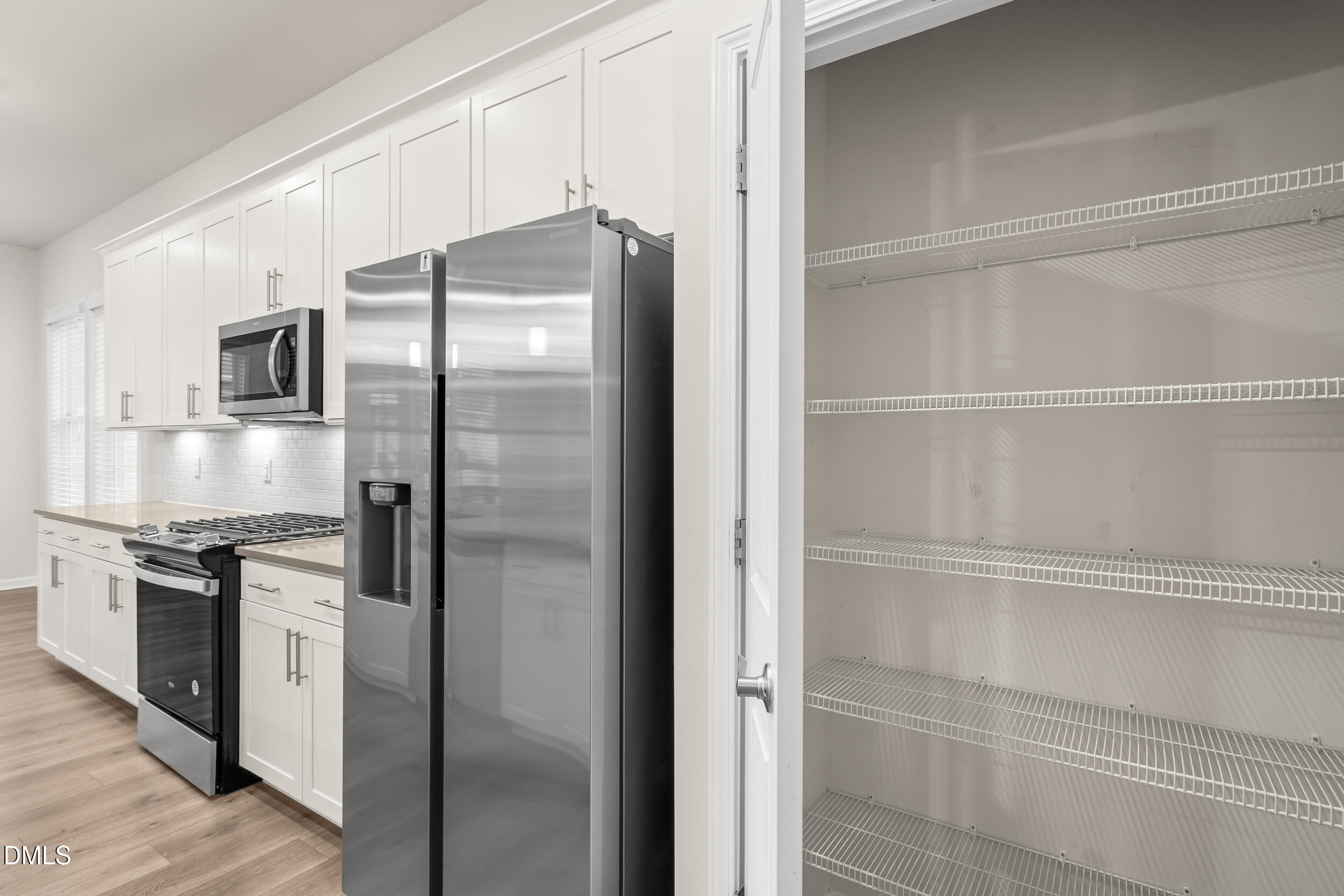 1 Bobby Parker Place Durham, NC 27703 - Photo 20 of 41 a kitchen with stainless steel appliances a refrigerator and cabinets