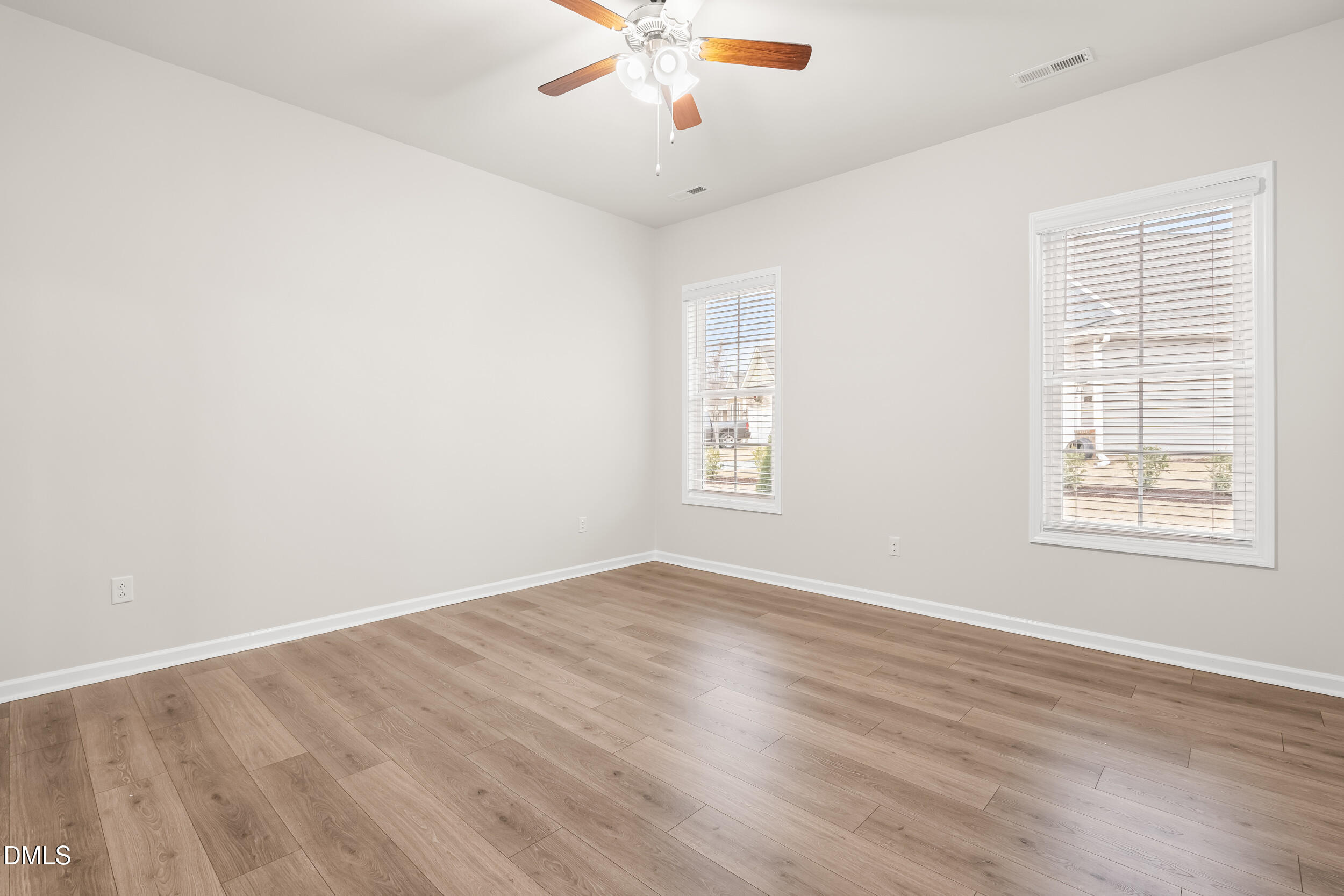 1 Bobby Parker Place Durham, NC 27703 - Photo 26 of 41 an empty room with wooden floor chandelier fan and windows