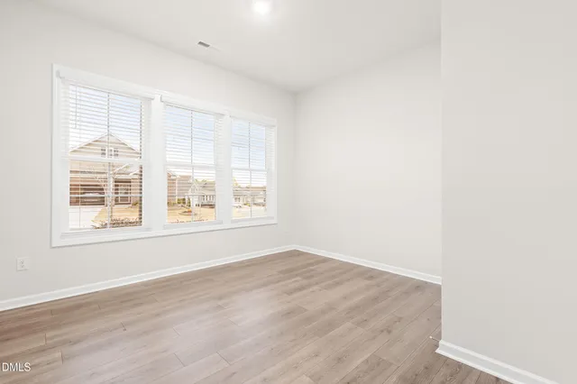 an empty room with wooden floor