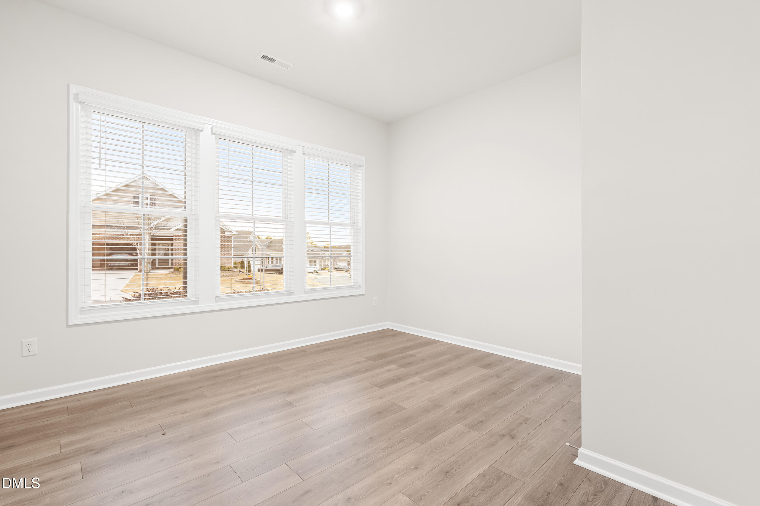 1 Bobby Parker Place Durham, NC 27703 - Photo 7 of 41 an empty room with wooden floor and windows