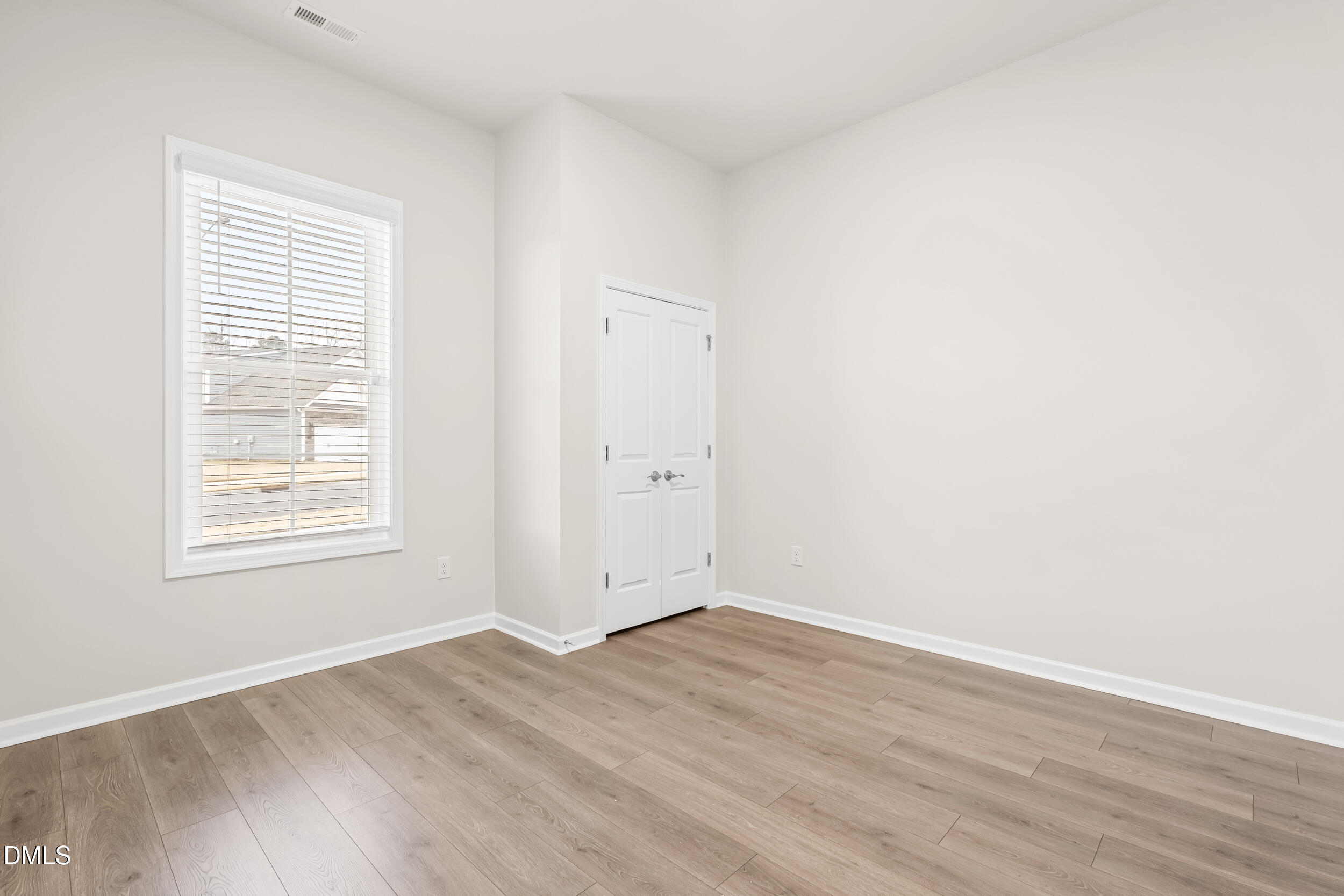 1 Bobby Parker Place Durham, NC 27703 - Photo 9 of 41 an empty room with wooden floor and windows