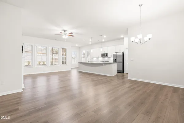 a view of a room with wooden floor