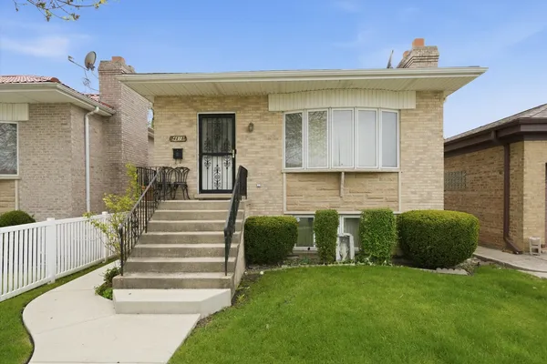 a front view of a house with a garden