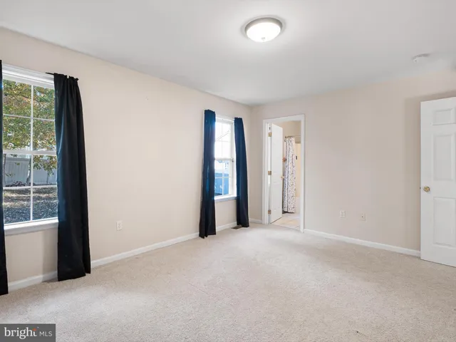 an empty room with sliding door and windows