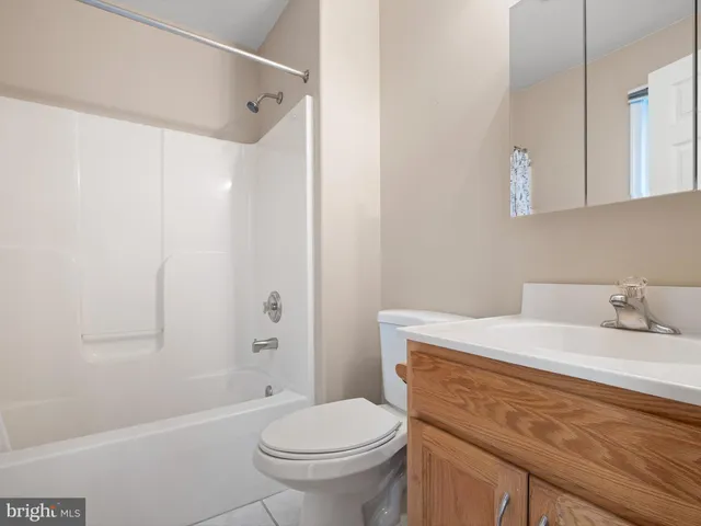 a bathroom with a sink toilet vanity and shower