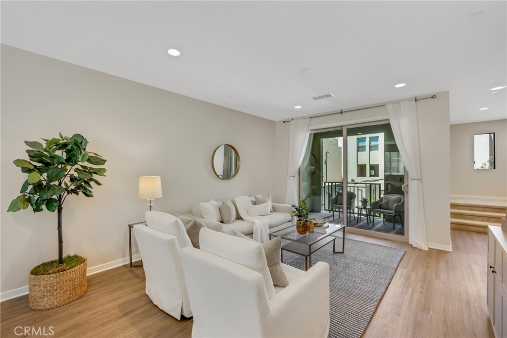 181 Magnet Irvine, CA 92618 - Photo 15 of 45 a living room with furniture potted plant and a wooden floor