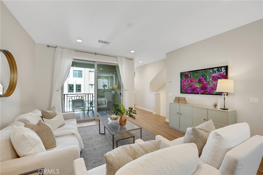 181 Magnet Irvine, CA 92618 - Photo 17 of 45 a living room with furniture and a floor to ceiling window