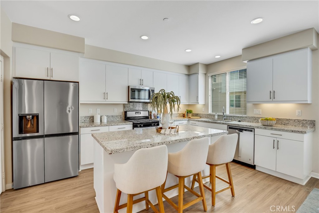 181 Magnet Irvine, CA 92618 - Photo 25 of 45 a kitchen with stainless steel appliances granite countertop a table chairs sink refrigerator and cabinets