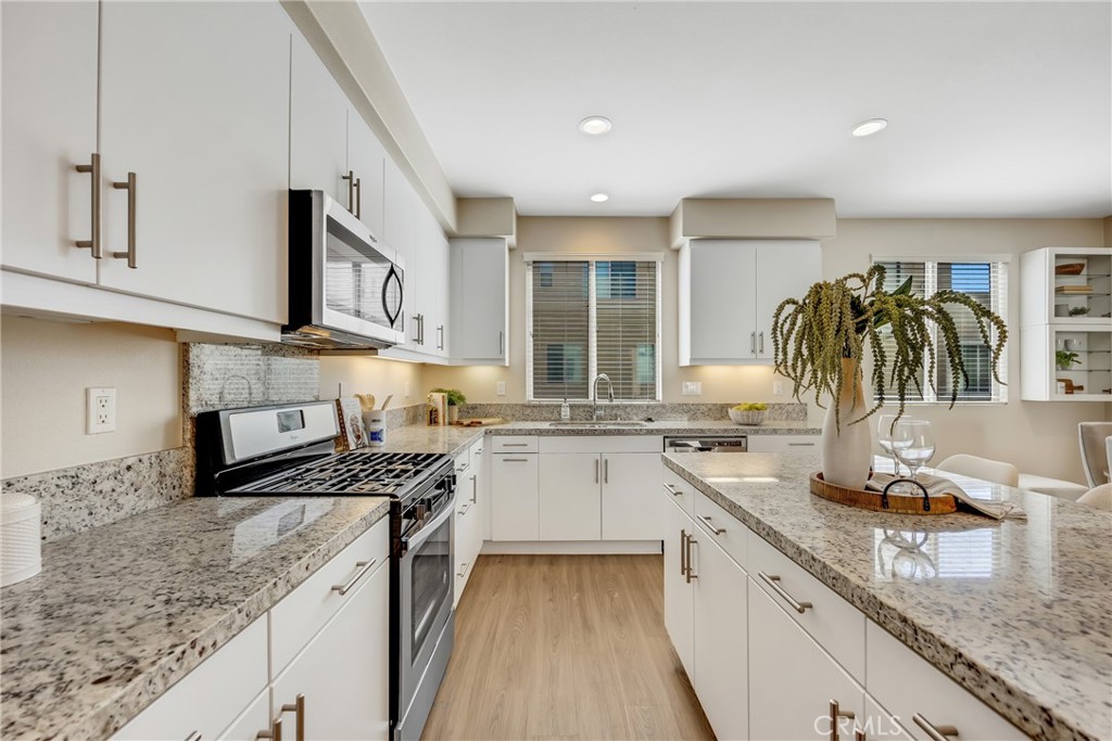 181 Magnet Irvine, CA 92618 - Photo 26 of 45 a kitchen with stainless steel appliances granite countertop a sink stove and cabinets