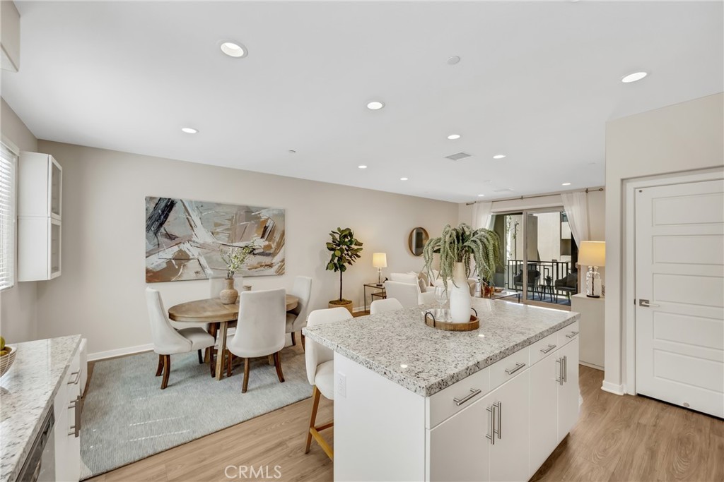 181 Magnet Irvine, CA 92618 - Photo 28 of 45 a kitchen with granite countertop kitchen island stainless steel appliances a dining table and chairs